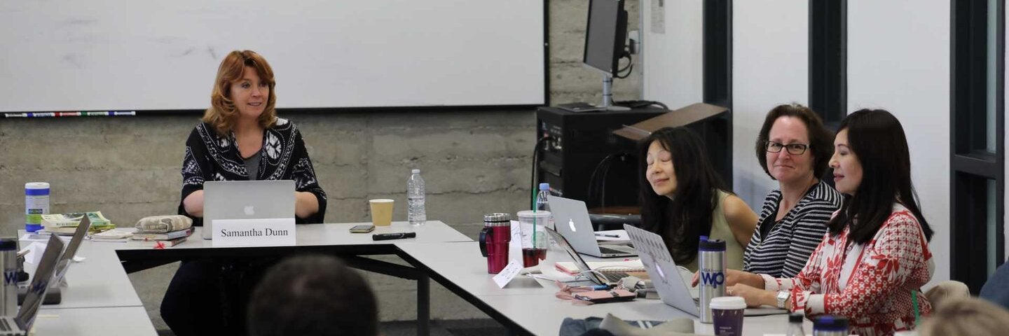 Writers collaborating at a round table.