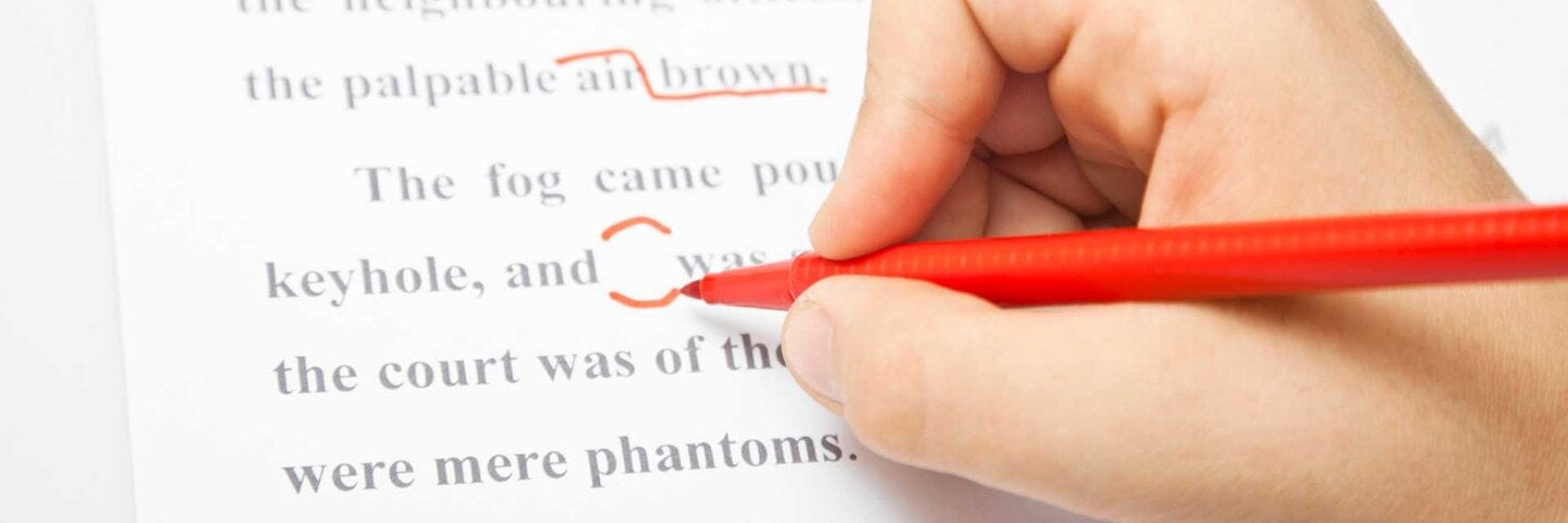 Copywriter noting corrections on a document.