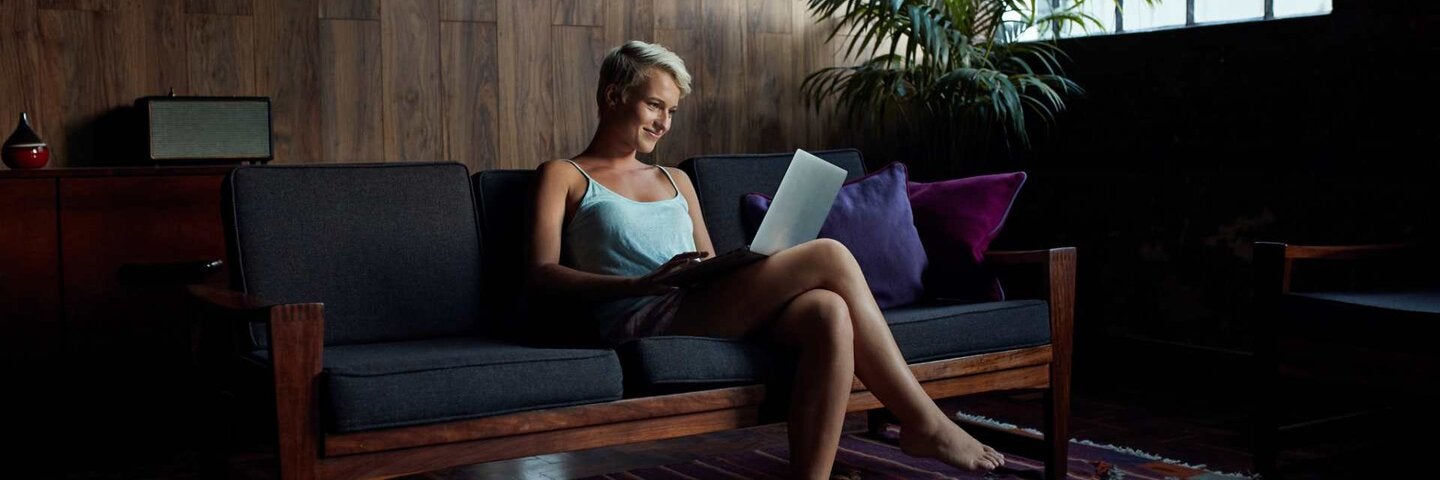 Young woman using laptop in urban apartment