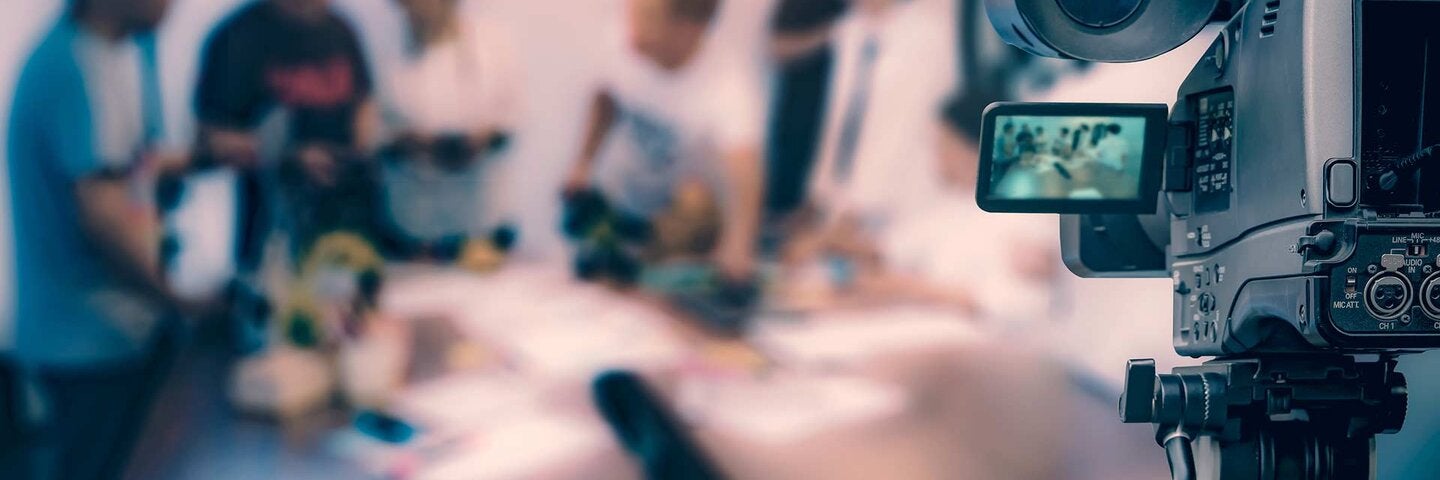 Video camera taking live video streaming at people working background