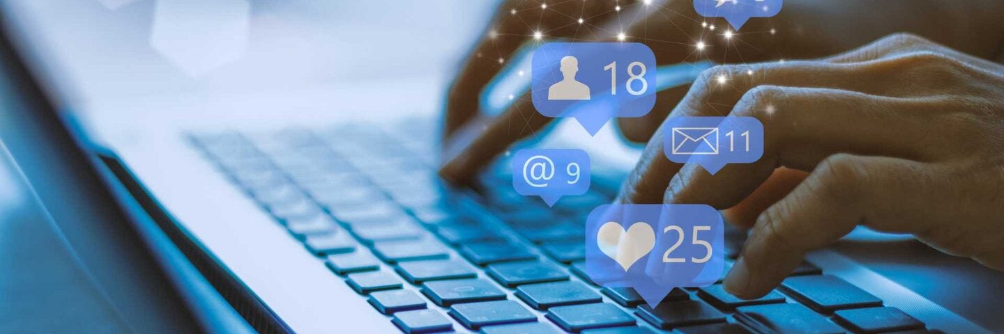 Businesswoman on laptop using social media