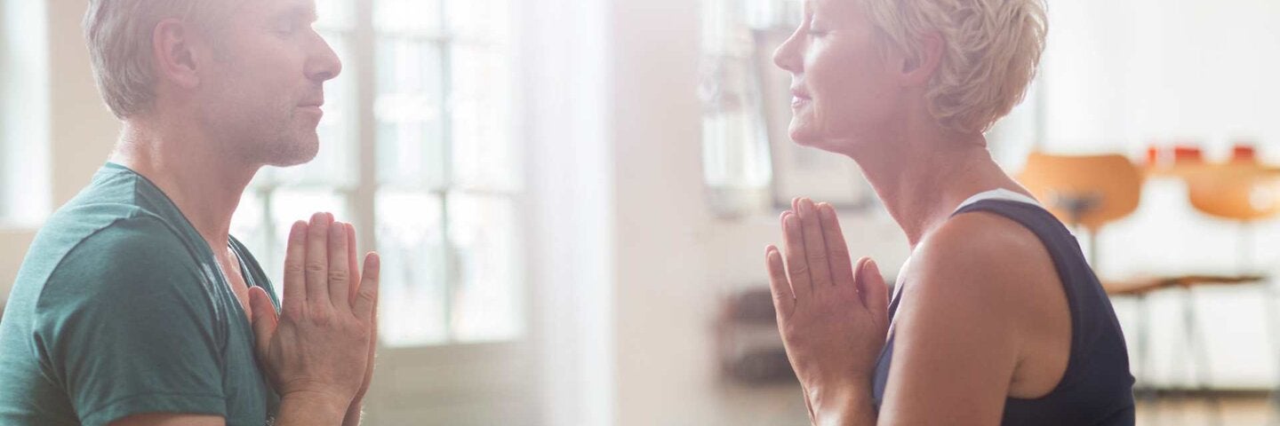 Active seniors practicing yoga together