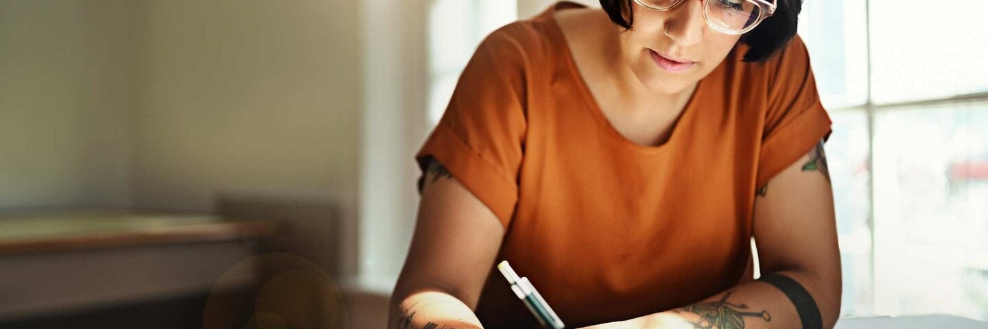 woman writing on paper