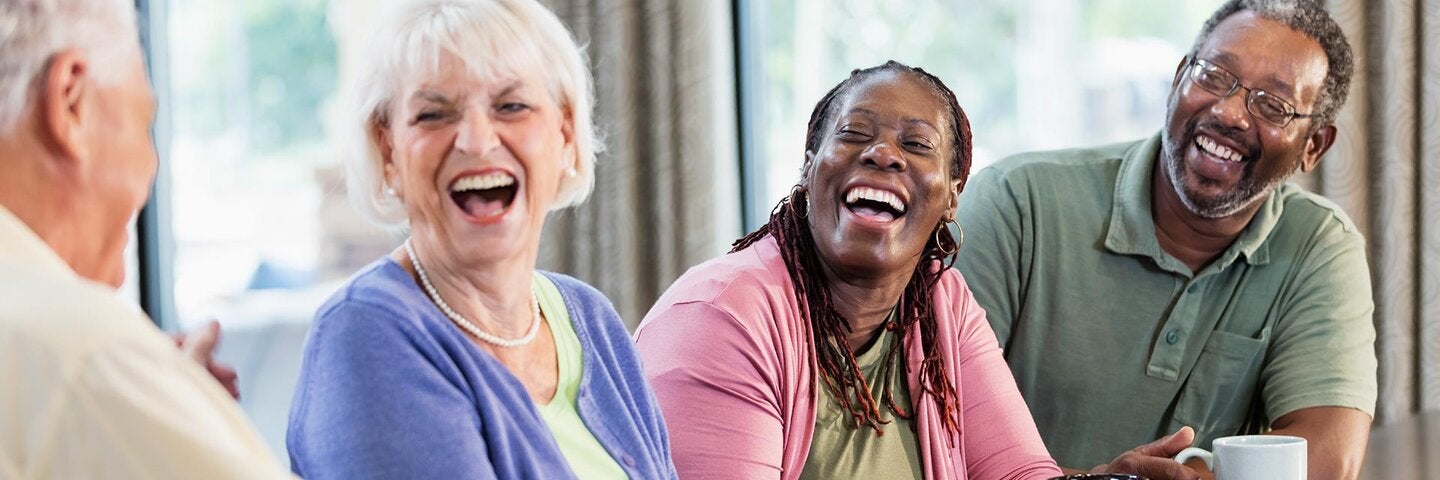 two senior couples at a table drinking coffee