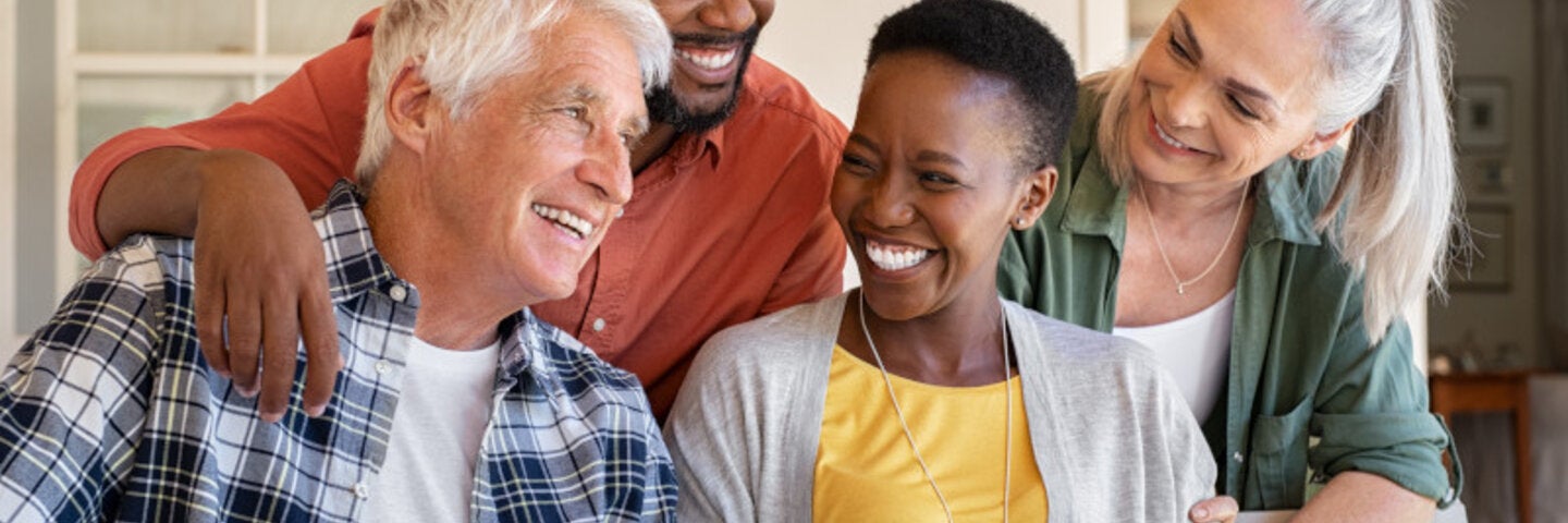 four people sitting together and smiling