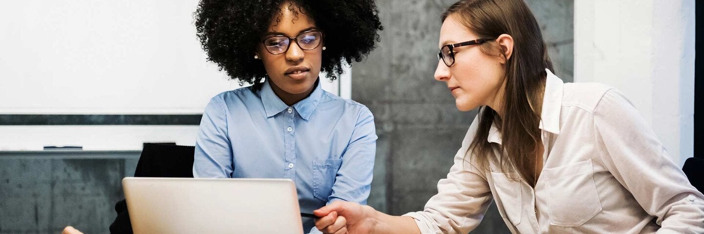 Two young women having a discussion in a business 