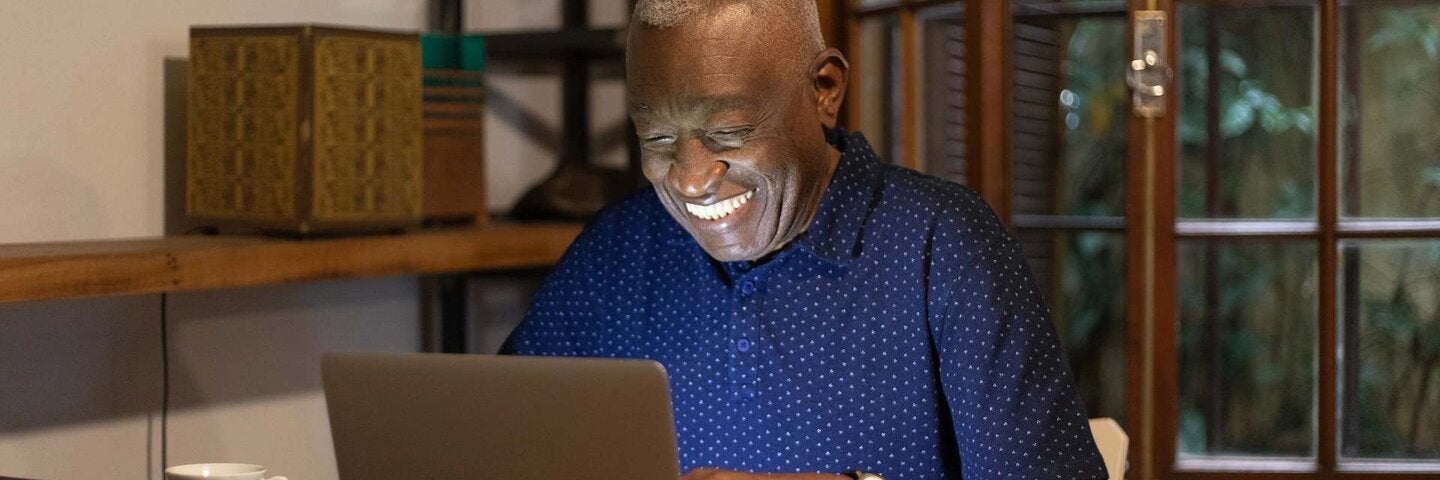 55+ man watching laptop