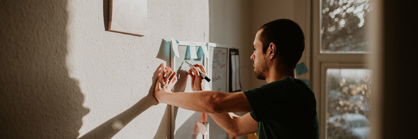 Man working through ideas on a whiteboard