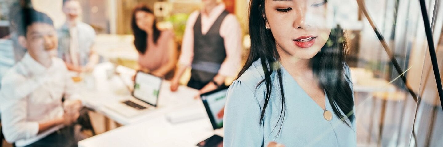 Asian Businesswoman presenting her ideas for company development