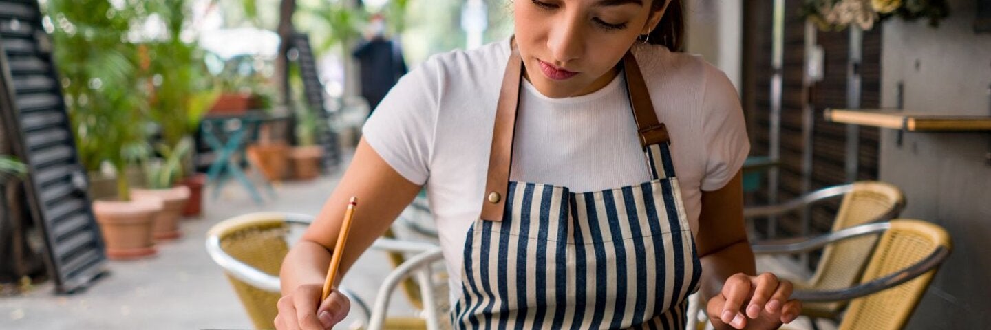 Business owner working at a cafe doing the books