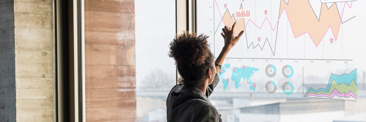 Woman analyzing AI graph projected to window