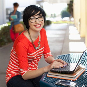 woman on laptop red shirt
