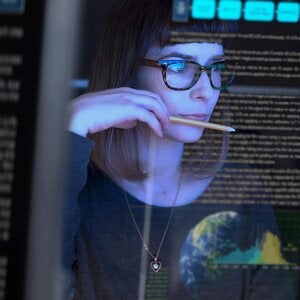 professional looking at a computer screen with alot of data