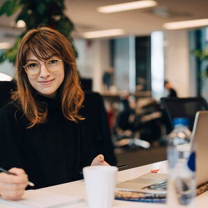 woman at desk looking at camera