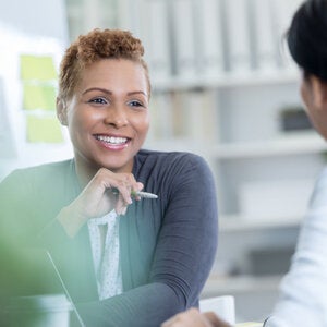 business professional woman in gray sweater