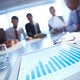 Business meeting with data on tablet